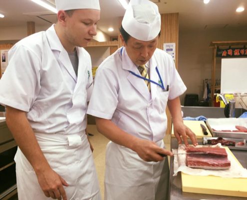 Working with a block of tuna at Tokyo Sushi Academy Working with a block of tuna at Tokyo Sushi Academy
